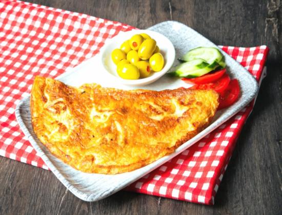 hands working with fresh pizza dough on floured surface
